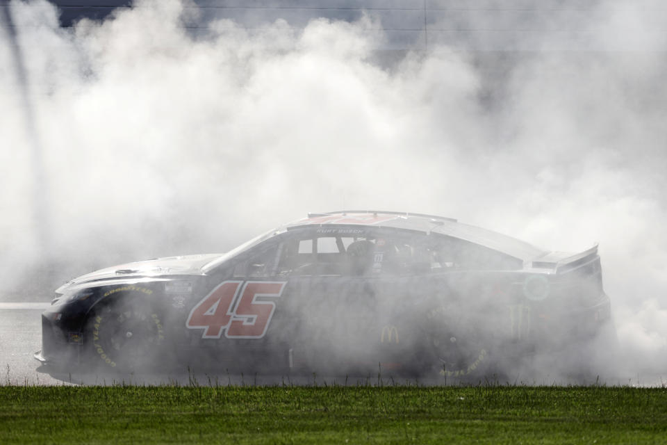 Kurt Busch (45) does a burnout after winning a NASCAR Cup Series auto race at Kansas Speedway in Kansas City, Kan., Sunday, May 15, 2022. (AP Photo/Colin E. Braley)