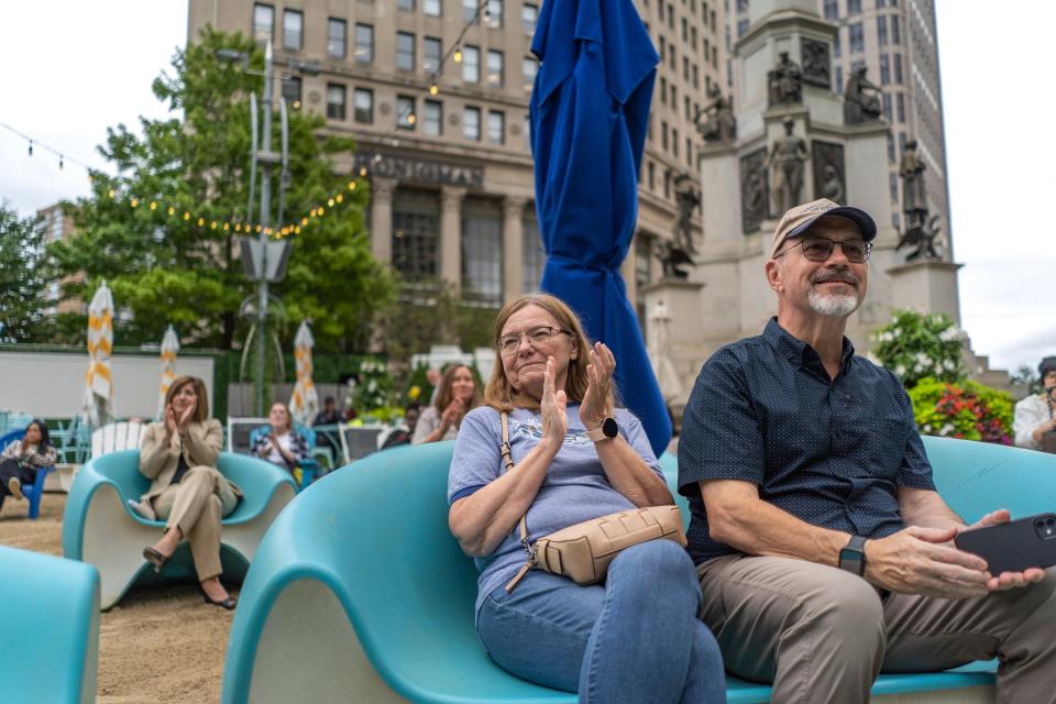 Jan Arnold , center, of Warren and her husband Dave Arnold listen to a quartet from the Detroit Symphony Orchestra play a piece while previewing the upcoming season with a performance at the beach in Campus Martius Park in Detroit on Friday, September 8, 2023.