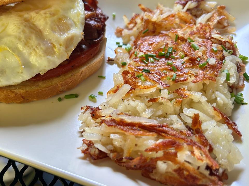 Cafe at the Plaza's classic chive hash browns are a little crispy, a little buttery, and an all-around comforting brunch side dish.