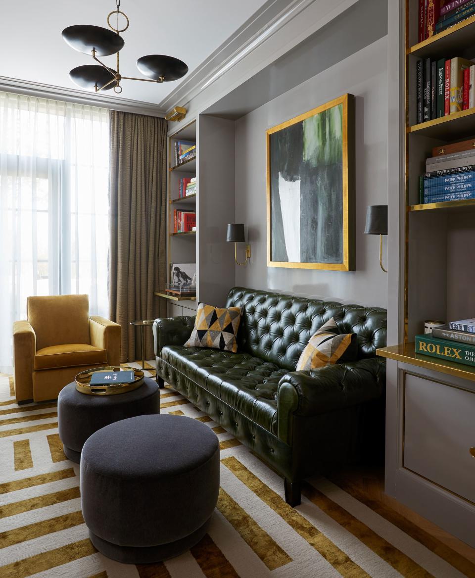 A custom gray lacquer from Fine Paints of Europe envelops JJ’s study. Adam Otlewski sconces with hand-dyed green leather shades flank a painting by Jane Swavely above the Michael Aiduss sofa of a dark green waxed leather. The modernist silk carpet is from Newel Gallery.