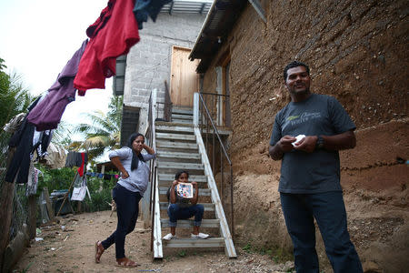 Douglas Almendarez, 37, a deportee from the U.S. who was separated from his son Eduardo Almendarez, 11, at the Rio Grande entry point under the Trump administration's hardline immigration policy, speaks next to his wife Evelin Meyer, 38 and Marcela, 9, his daughter, in La Union, in Olancho state Honduras July 14, 2018. Picture taken July 14, 2018. REUTERS/Edgard Garrido