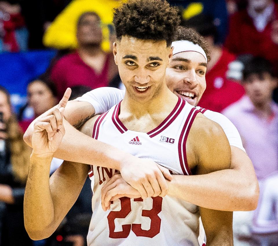 Indiana's Trayce Jackson-Davis (23) and Race Thompson (25) celebrate the victory after overtime of the Indiana versus Michigan men's basketball game at Simon Skjodt Assembly Hall on Sunday, March 5, 2023.