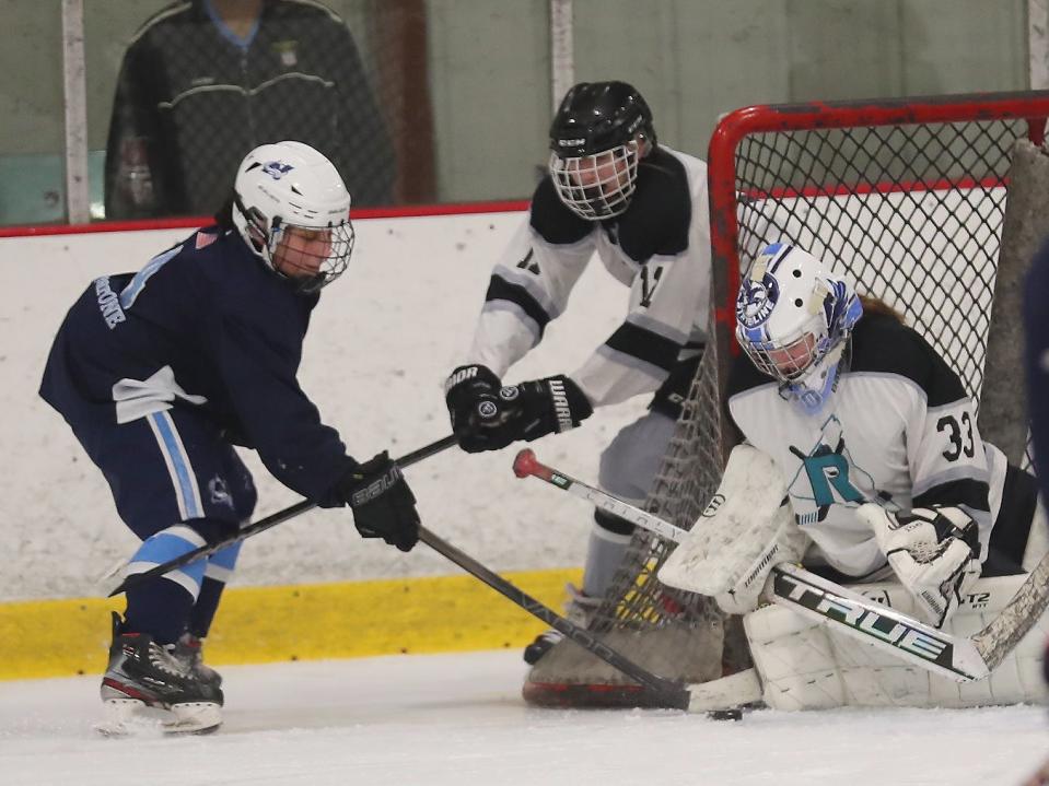 From left, North Avalanche's Piper Ackner (4) tries to get a shot by Rockland Rockies goalie Colette Curley (33) during the Section 1 girls hockey championship at the Brewster Ice Arena Feb. 8, 2024. Feb. 7, 2024. The Avalanche won the game 4-0.