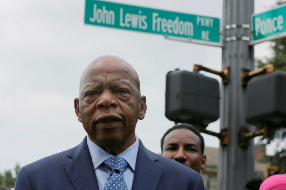 Rep. John Lewis stands in front of John Lewis Freedom Parkway moments after its new name was unveiled in Atlanta on Aug. 22, 2018. 