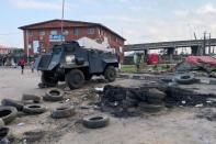 A police vehicle is pictured at a police checkpoint that was burnt down in Lagos