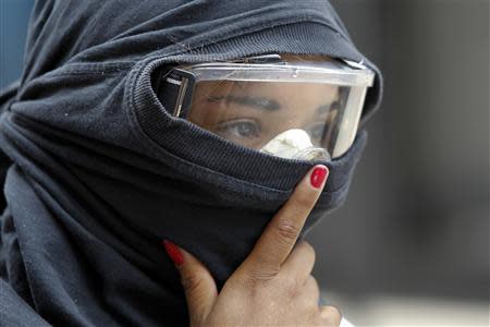 An anti-government protester stands during riots with police in Caracas April 17, 2014. REUTERS/Christian Veron