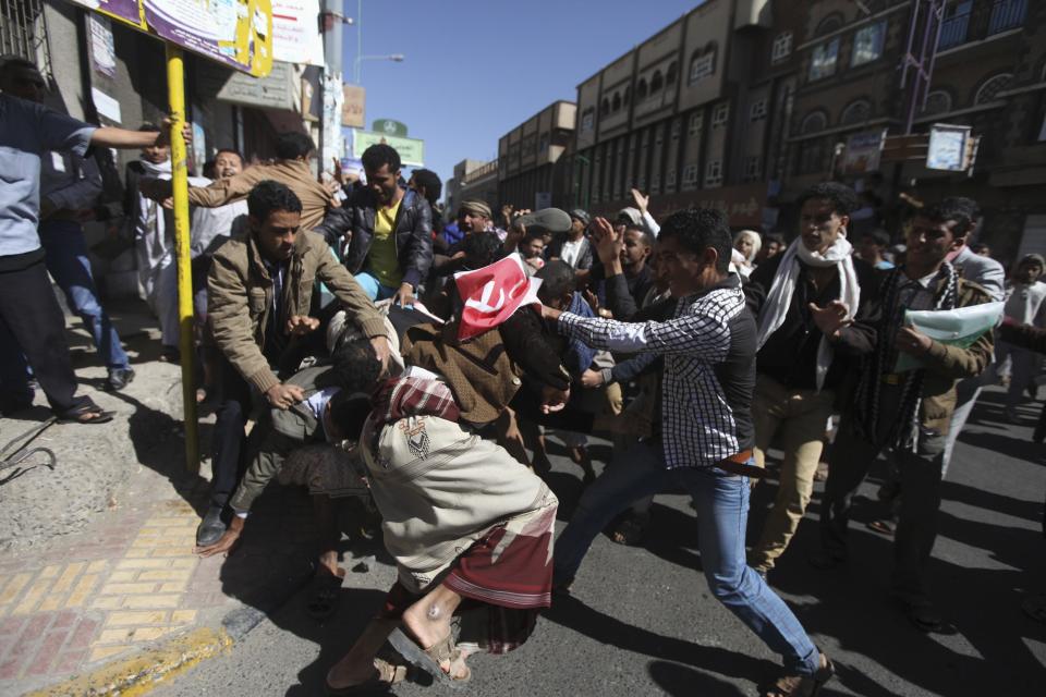 Supporters of the Houthi movement clash with anti-Houthi protesters during a rally in Sanaa