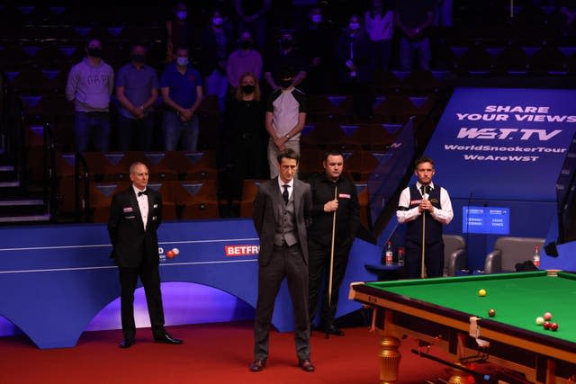 Presenter Rob Walker, Stephen Maguire, Jamie Jones and spectators observed a minute’s silence at the Crucible