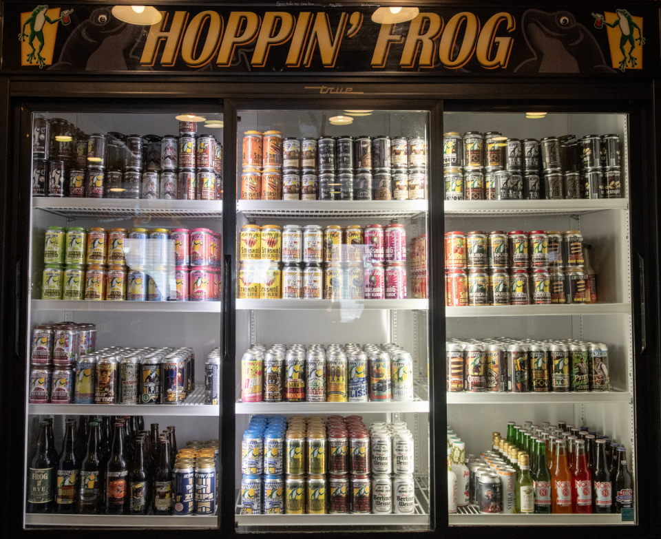 Hoppin' Frog sells four-pack cans and bottles out of its cooler.