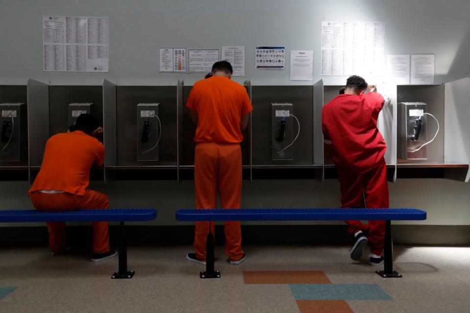 Detainees talk on telephones at the Adelanto ICE Processing Center in Adelanto, California (Copyright 2019 The Associated Press. All rights reserved)