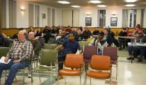 Workers from the Philadelphia Energy Solutions refinery owned by the Carlyle Group in south Philadelphia listen to United Steelworkers representatives during a union meeting in Norwood, Pennsylvania March 20, 2014. REUTERS/David M. Parrott