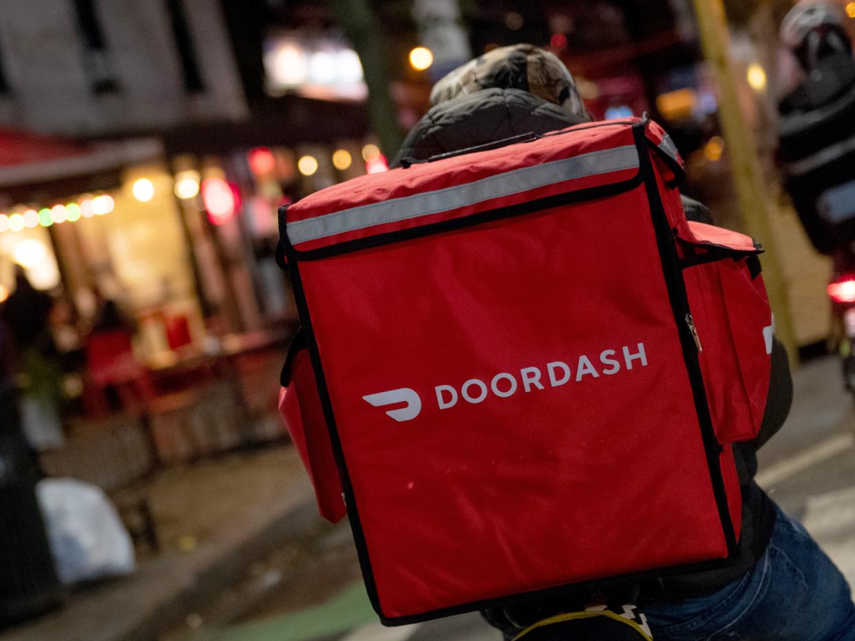 A door-dash delivery driver waits near a restaurant on December 30, 2020 in New York City.