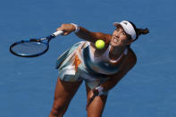 Garbine Muguruza of Spain serves to Clara Burel of France during their first round match at the Australian Open tennis championships in Melbourne, Australia, Tuesday, Jan. 18, 2022. (AP Photo/Hamish Blair)