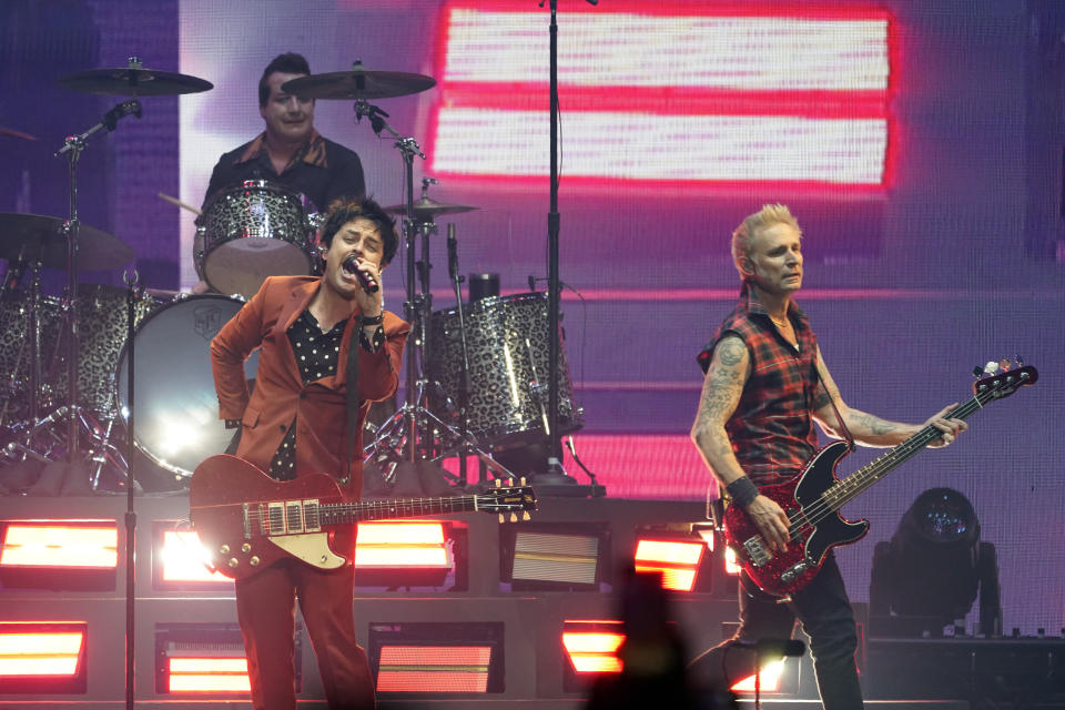 Billie Joe Armstrong, left, Mike Dirnt, right, and Tre' Cool, top left, of the band Green Day perform on day three of the Bud Light Super Bowl Music Fest, Saturday, Feb. 12, 2022, at Crypto.com Arena in Los Angeles. (AP Photo/Chris Pizzello)
