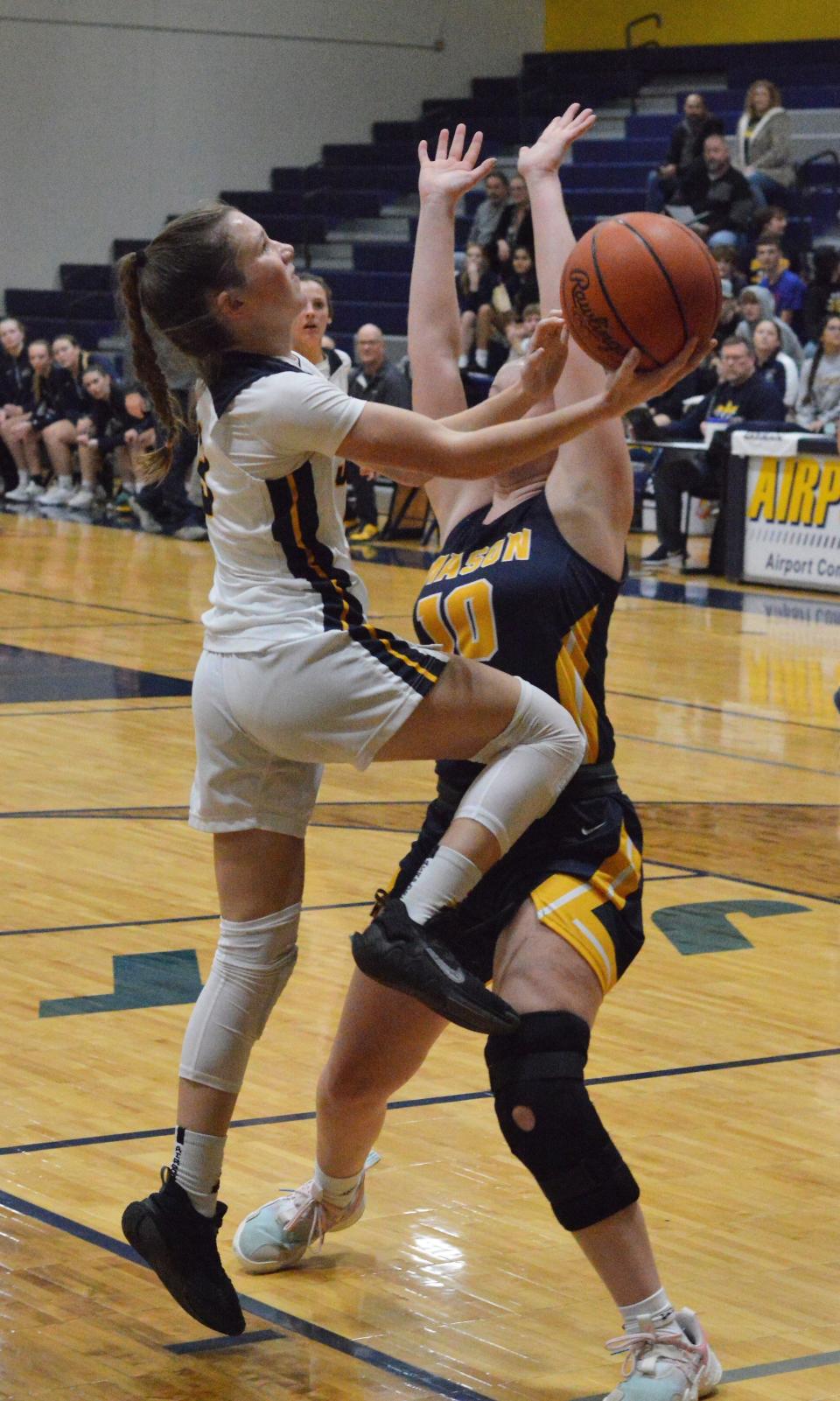 Airport's Breanna Baker gets tangled up with Jenna Wright of Erie Mason Tuesday night.