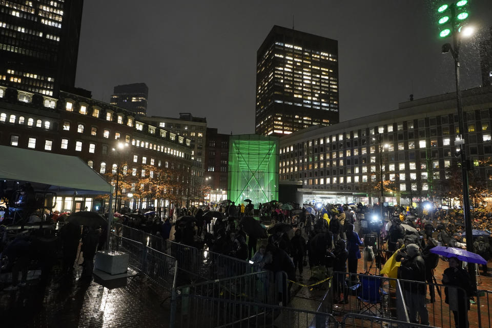 A Boston MBTA subway station is illuminated with green light following a ceremony attended by Britain's Prince William and Kate, Princess of Wales, Wednesday, Nov. 30, 2022, in Boston. The ceremony was held to highlight the Earthshot Prize and environmental issues. (AP Photo/Steven Senne)