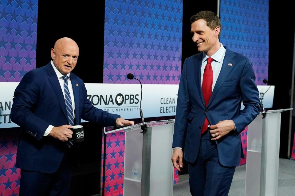 Arizona Democratic Sen. Mark Kelly, left, and his Republican challenger Blake Masters, right, arrive on stage prior to a televised debate in Phoenix, Thursday, Oct. 6, 2022. (AP Photo/Ross D. Franklin) ORG XMIT: AZRF105