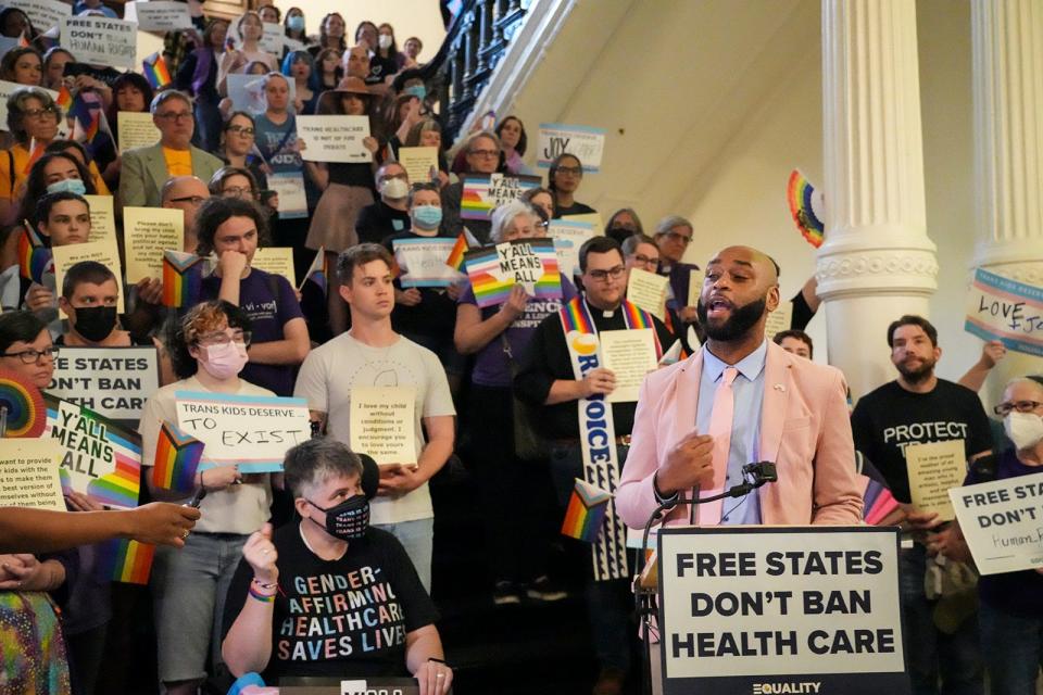 Rep. Christian Manuel, D-Beaumont, speaks in support of LGBTQ+ rights activists as they filled the stairs and hallway in front of the House chamber Friday.