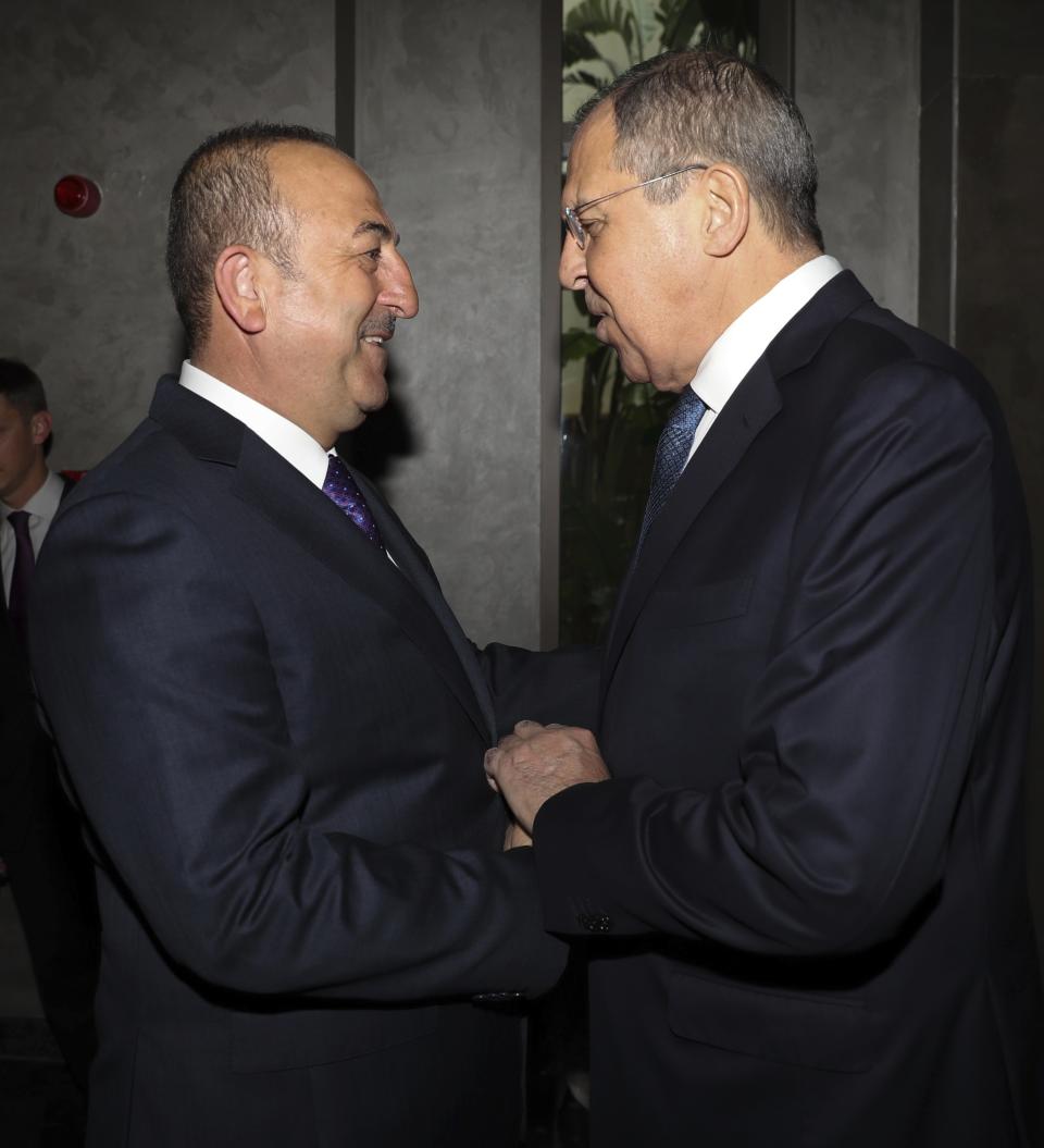 Turkey's Foreign Minister Mevlut Cavusoglu, left, greets his Russian counterpart Sergey Lavrov prior to their meeting in the Mediterranean coastal city of Antalya, Turkey, Friday, March 29, 2019. The two ministers attending the Turkey - Russia Joint Strategic Group Meeting which comes ahead of municipal elections scheduled to be held across Turkey on Sunday March 31. (Turkish Foreign Ministry via AP, Pool)