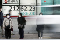 Pedestrians stand in front of an electronic stock board showing Japan's Nikkei 225 index at a securities firm in Tokyo Friday, Feb. 28, 2020. Asian stock markets have fallen further on virus fears after Wall Street endured its biggest one-day drop in nine years. (AP Photo/Eugene Hoshiko)