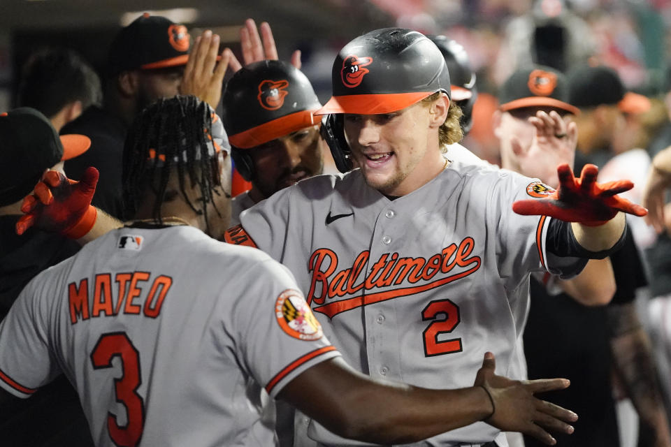 Baltimore Orioles' Gunnar Henderson (2) celebrates with Jorge Mateo (3) in the dugout after hitting a three-run home run during the seventh inning of a baseball game against the Los Angeles Angels, Monday, Sept. 4, 2023, in Anaheim, Calif. Anthony Santander and Ryan Mountcastle also scored. (AP Photo/Ryan Sun)