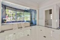 <p>Here’s one of the home’s six full bathrooms. This one has an elegant soaker tub. (Sotheby’s International Realty) </p>