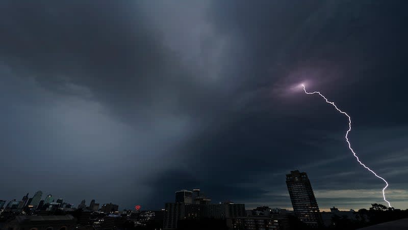 FILE - Lightning strikes in the distance as a thunderstorm passes over downtown Kansas City, Mo., July 30, 2023. 15 million people in the Midwest and Plains regions will see extreme weather this week, including tornados. (AP Photo/Charlie Riedel, File)