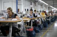 Workers make shoes at the footwear factory 'Dermal' in Kotor Varos