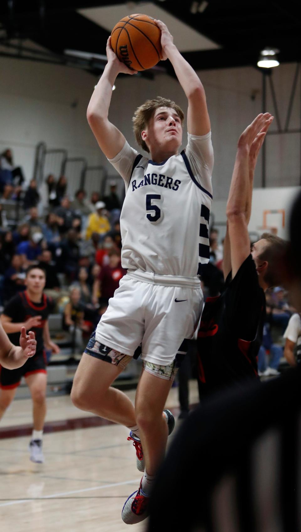 Redwood's Zander Jensen goes up strong against North during their 72nd annual Polly Wilhelmsen Invitational Basketball Tournament semifinal game in Visalia, Calif., Friday, Dec. 29, 2023.