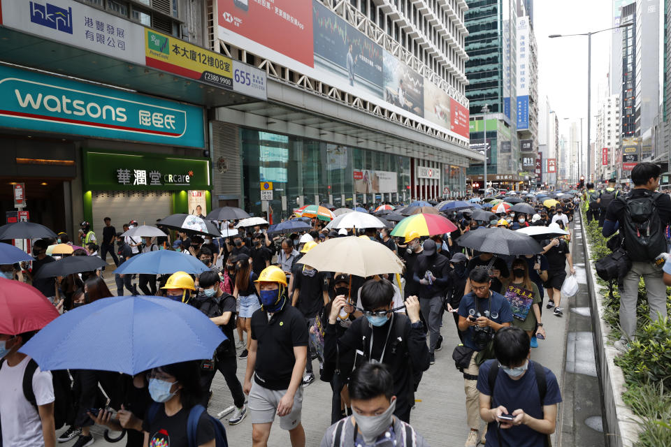 Protesters march through the Mong Kok neighborhood during a demonstration in Hong Kong, Saturday, Aug. 3, 2019. Hong Kong protesters ignored police warnings and streamed past the designated end point for a rally Saturday in the latest of a series of demonstrations targeting the government of the semi-autonomous Chinese territory. (AP Photo/Vincent Thian)