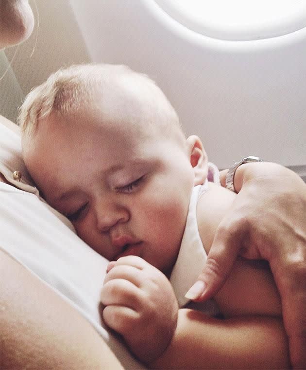 What every parent dreams about: a happily sleeping baby on a flight. Photo: Getty