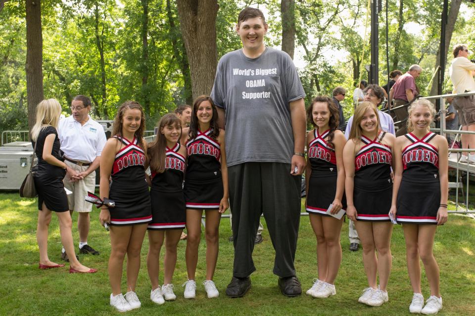 In this 15 August 2011 photo, Igor Vovkovinskiy takes a photo with cheerleaders from the Cannon Falls high school prior to a President Barack Obama town hall event at Lower Hannah's Bend Park in Cannon Falls (AP)