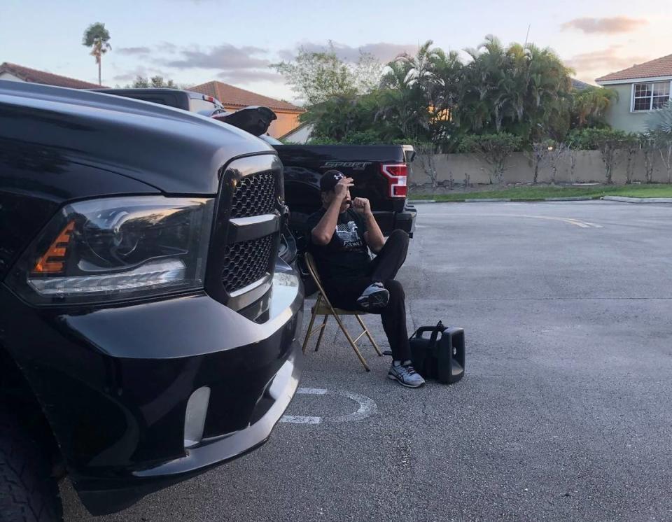 A man who wouldn’t give his name uses a loudspeaker to campaign for President Donald Trump outside the polling place at the Cooper City community center on Stonebridge Parkway on Election Day, Tuesday, Nov. 3, 2020. 