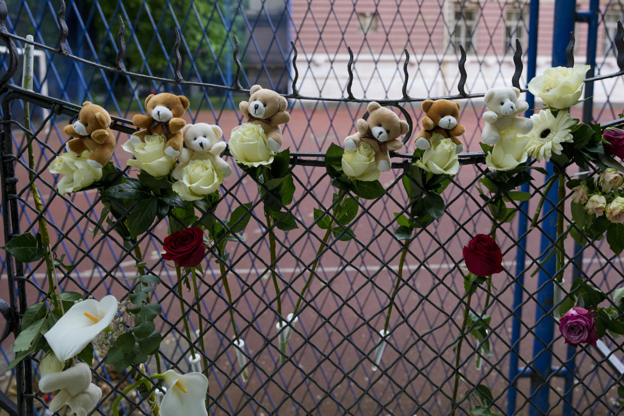 Flowers and toys are placed for the victims near the Vladislav Ribnikar school in Belgrade, Serbia, Thursday, May 4, 2023. A 13-year-old who opened fire Wednesday at his school in Serbia's capital. He killed multiple fellow students and a guard before calling the police and being arrested. Several children and a teacher were also hospitalized. (AP Photo/Darko Vojinovic)