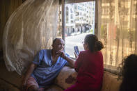 Afifa, right, and her husband, Moustafa, video call with their relatives on the first day of Eid in lockdown due to the Coronavirus pandemic, in Casablanca, Morocco, Sunday, May 24, 2020. Instead of mass prayers and large family gatherings filled with colorful clothes, gifts, and traditional foods, millions of Moroccan Muslims celebrated Eid Al-Fitr at home, subdued and isolated amid their country's newly extended coronavirus lockdown. (AP Photo/Mosa'ab Elshamy)