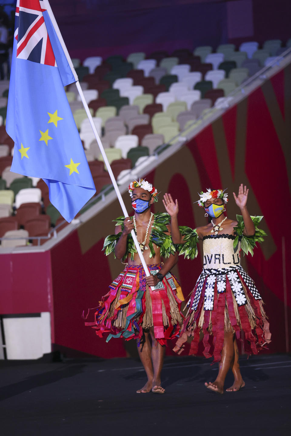 <p>TOKYO, JAPAN - JULY 23: Flag bearers Matie Stanley and Karalo Hepoiteloto Maibuca of Team Tuvalu during the Opening Ceremony of the Tokyo 2020 Olympic Games at Olympic Stadium on July 23, 2021 in Tokyo, Japan. (Photo by Jamie Squire/Getty Images)</p> 