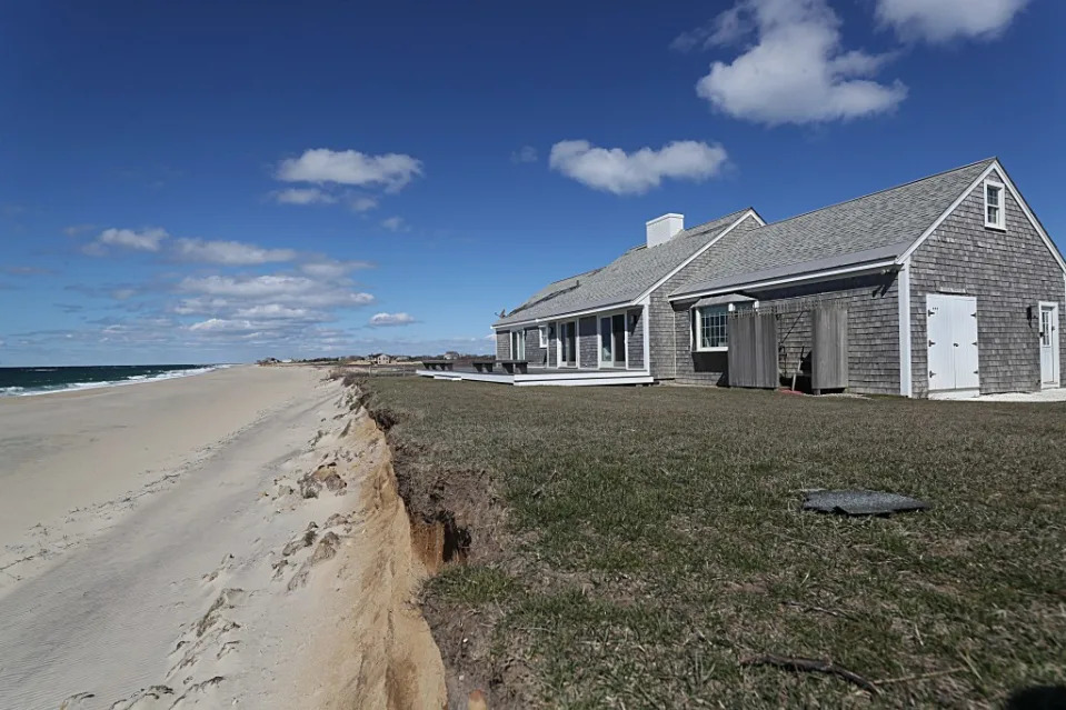 The house at 6 Sheep Pond Road, which recently sold for $600,000 after losing 30 feet of dune. Boston Globe via Getty Images