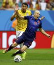 Brazil's Thiago Silva (L) fouls Arjen Robben of the Netherlands to concede a penalty during their 2014 World Cup third-place playoff at the Brasilia national stadium in Brasilia July 12, 2014. REUTERS/Dominic Ebenbichler (BRAZIL - Tags: SOCCER SPORT WORLD CUP TPX IMAGES OF THE DAY)