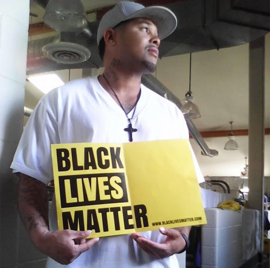 Jason Jones poses with a Black Lives Matter sign inside San Quentin State Prison. (Courtesy: Jason Jones)