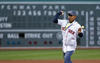 Meb Keflezighi, men's winner of the Boston Marathon earlier in the week, throws a ceremonial first pitch prior to a baseball game between the Boston Red Sox and the New York Yankees at Fenway Park in Boston, Wednesday, April 23, 2014. (AP Photo/Elise Amendola)