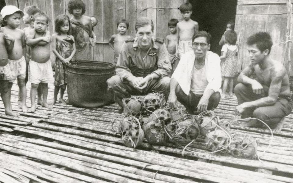 Charteris in 1964 with Iban headhunters and the skulls of Japanese soldiers they had killed during the Second World War