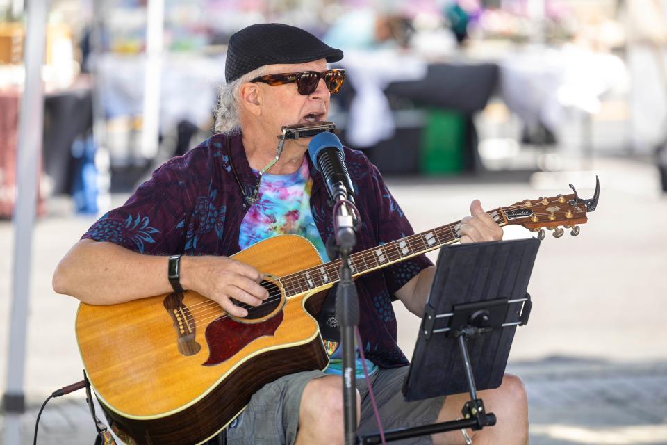 James Knight, half of the musical duo It’s About Time, entertains visitors to Ravenna’s Art on Main on Saturday, June 8, 2024 in downtown Ravenna.