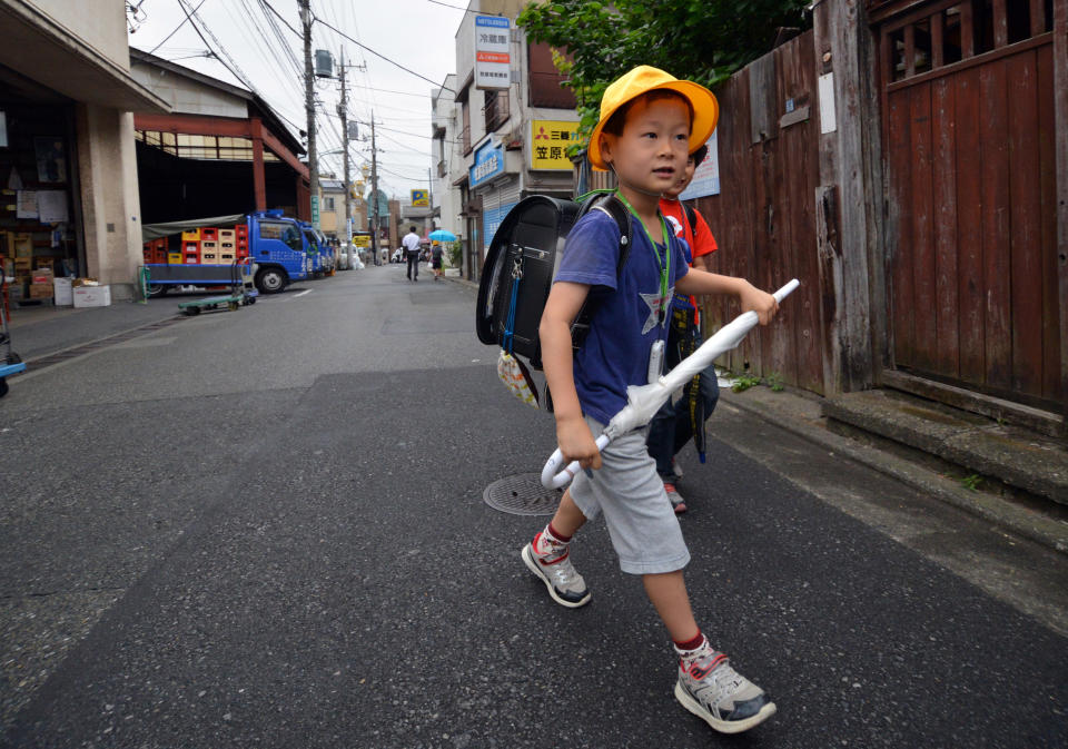 Six-year-old Japanese elementary student Seishi Nishida walks to school in Tokyo on June 11, 2013. 