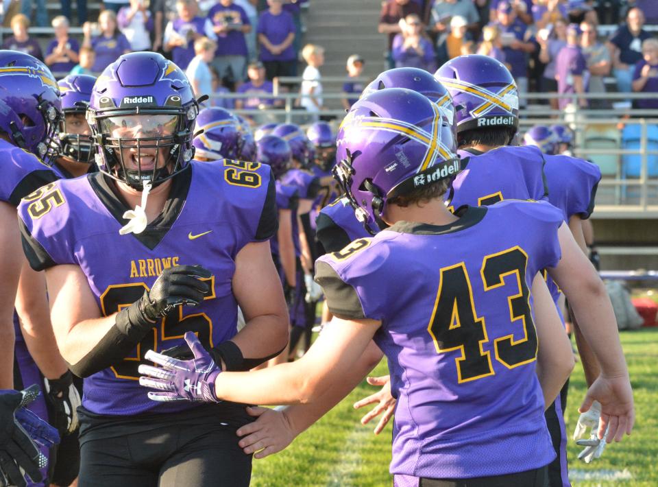 Watertown's Jayden Lambert (65) smacks hands with Gavyn Hanson (43) after being announced as a starter prior to their season-opening high school football game against Brookings on Friday, Aug. 25, 2023 at Watertown Stadium.