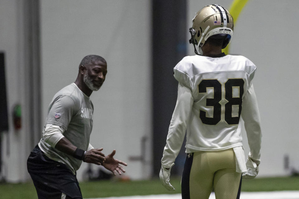 New Orleans Saints secondary coach Aaron Glenn, left, works with New Orleans Saints cornerback Keith Washington Jr. (38) during an NFL football training camp practice inside the Ochsner Sports Performance Center in Metairie, La., Thursday, Aug. 27, 2020. (David Grunfeld, The Advocate via AP, Pool)