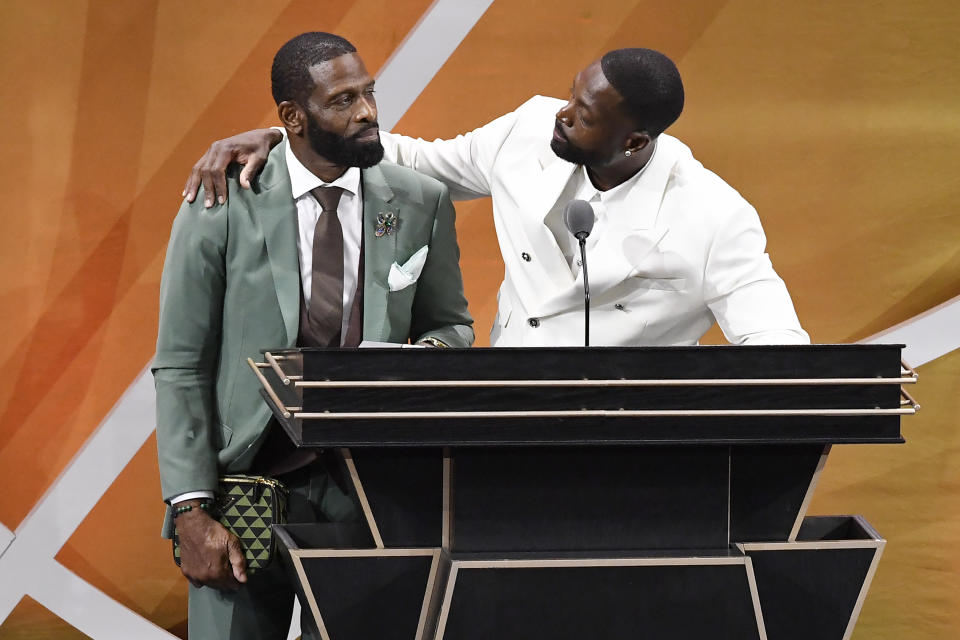 CORRECTS TO DWYANE NOT DWAYNE - Dwyane Wade, right, talks to his father Dwyane Wade Sr., left, during his enshrinement at the Basketball Hall of Fame, Saturday, Aug. 12, 2023, in Springfield, Mass. (AP Photo/Jessica Hill)