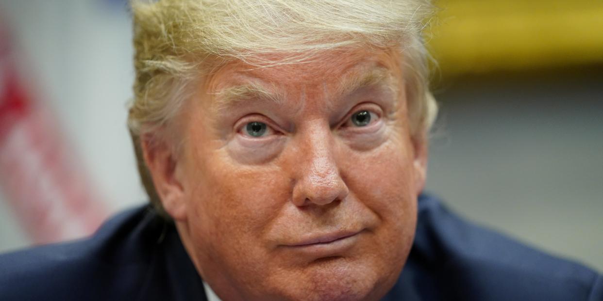 President Donald Trump listens to a question from a reporter while participating in a 