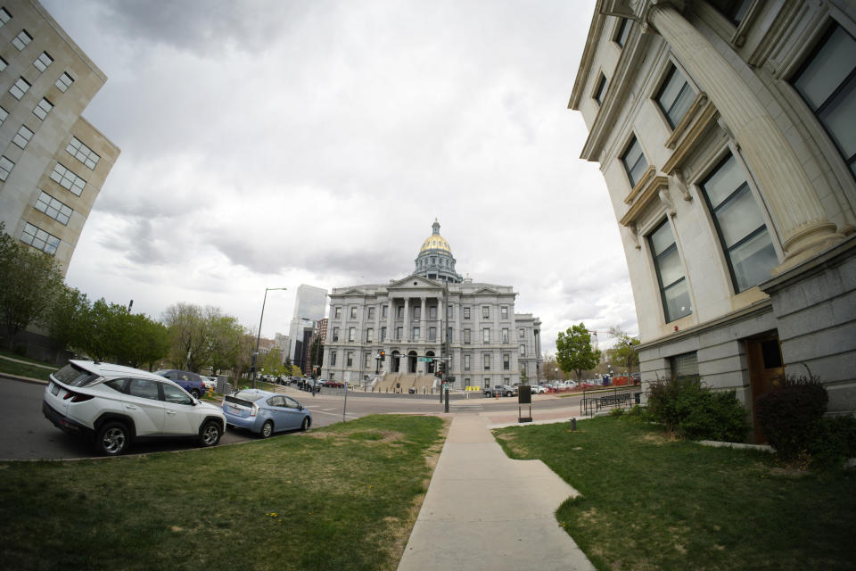 Heavy clouds roll over the State Capitol in this view from Sherman Street near the intersection of 14th Avenue, Monday, May 8, 2023, in Denver. (AP Photo/David Zalubowski)