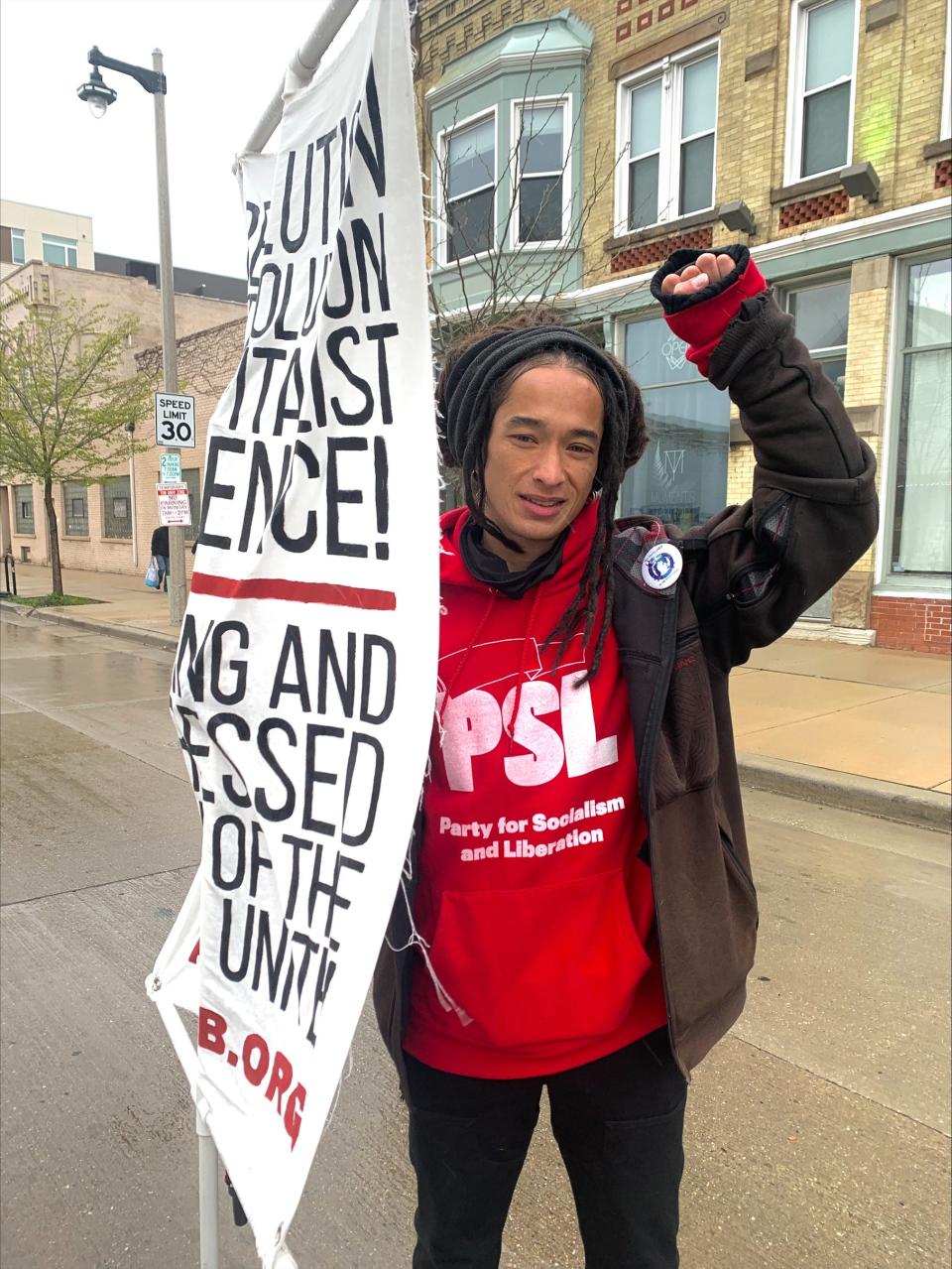 Nicholas Sinthasomphone ,36, of Milwaukee, prepares to march in the annual May Day demonstration in Milwaukee.