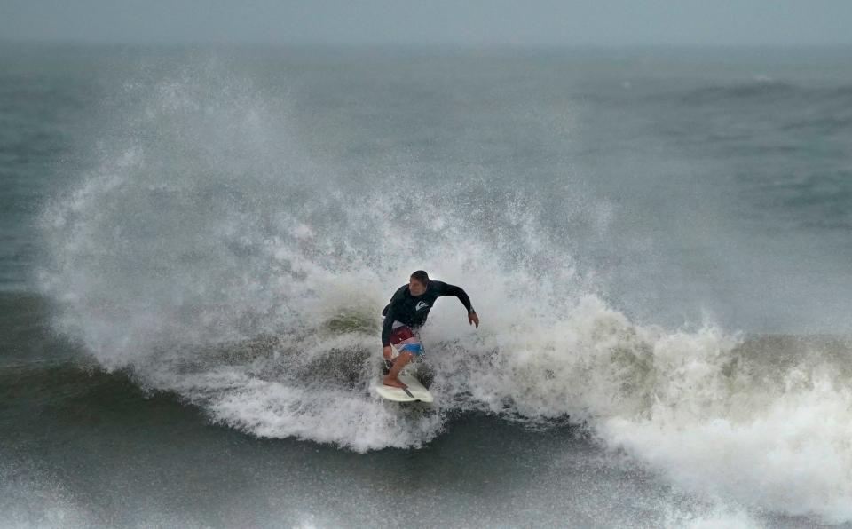 A surfer takes to the waves in Ponce Inlet as Hurricane Idalia's effects hit Volusia County in August. More rough surf is expetced this weekend due to Hurricane Lee out in the Atlantic.